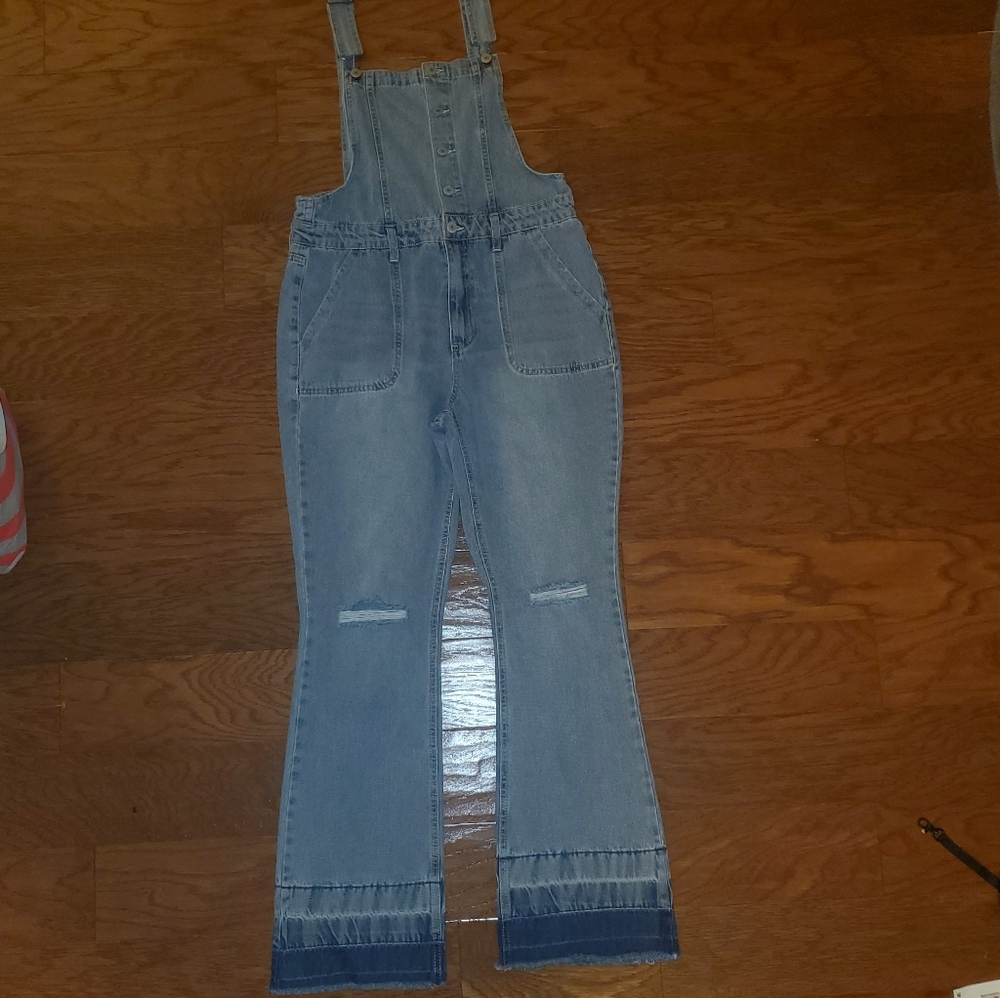 Bell-bottom overalls with indigo-died bottoms.